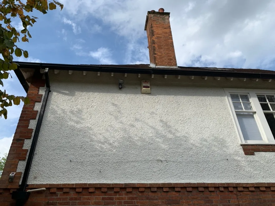 Gable and chimney above the rendered upper storey