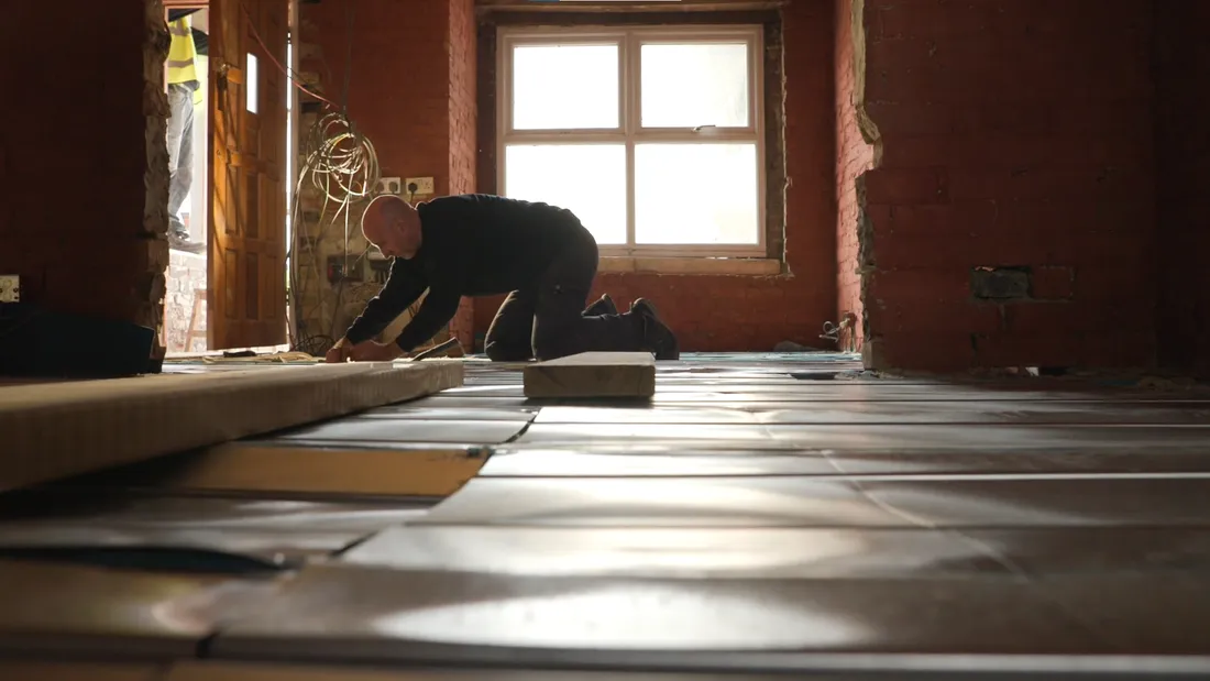 The ground floor of the terrace opened up during the works, metal heating trays laid across the insulated floor
