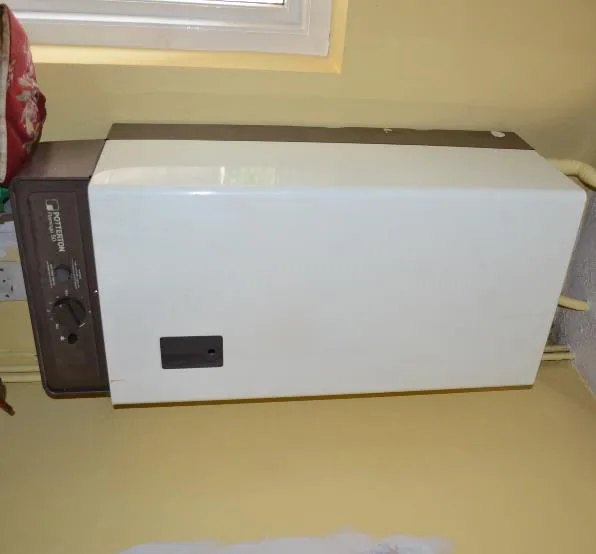 The old wall-hung gas boiler before replacement
