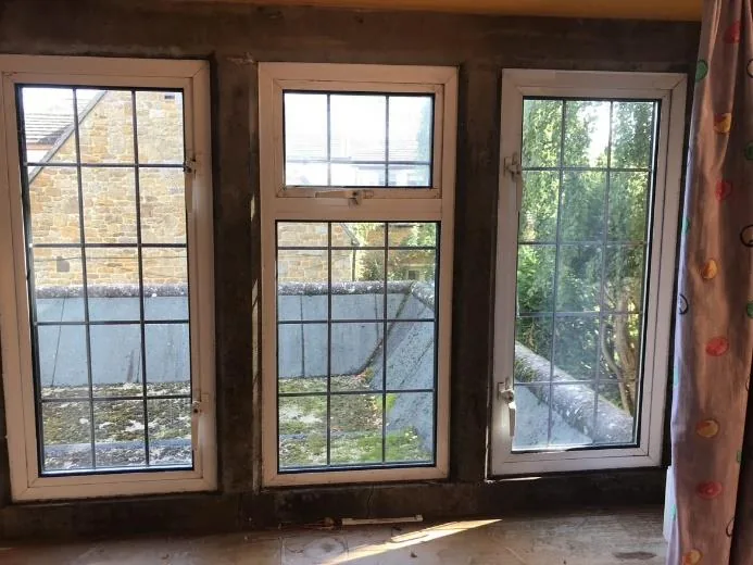 A bedroom's three-light mullioned window opening before works