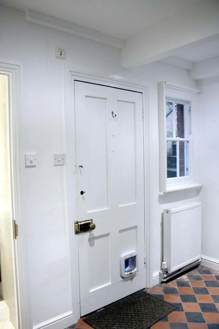 A lower-ground room below pavement level, insulated with capillary-active calcium-silicate board