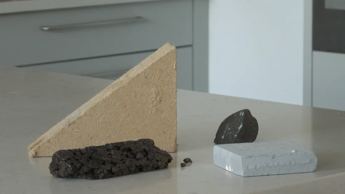 Offcuts of wood fibre, cellular glass and board insulation from the build, lined up on a worktop