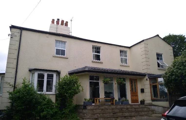 Rendered 1900s detached house before external wall insulation works