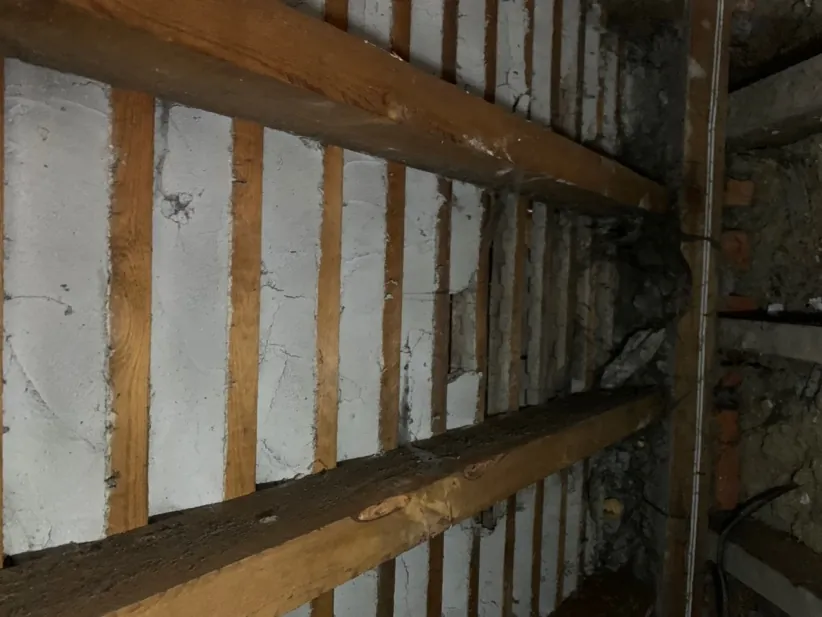 Inside the Church Way roof before works — lime torching between battens and no insulation in the slope